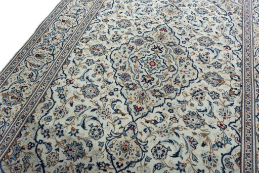Backside of handmade 2000s Kashan rug showing knot structure and weave density