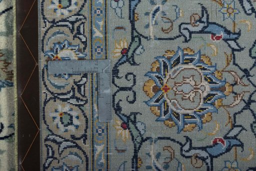 Backside of handmade 2000s Kashan rug showing knot structure and weave density