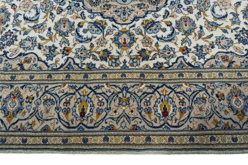 Corner detail of 2000s Kashan rug showing border pattern and Wool pile