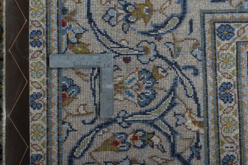Backside of handmade 2000s Kashan rug showing knot structure and weave density