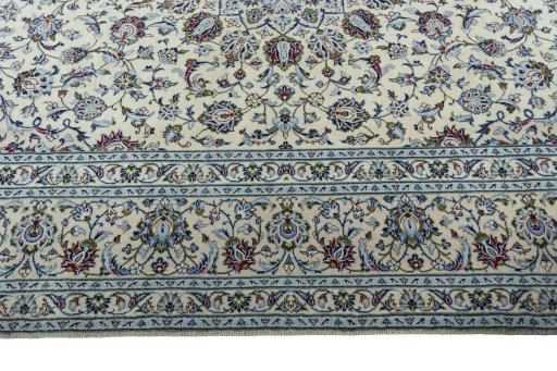 Corner detail of 2000s Kashan rug showing border pattern and Wool pile