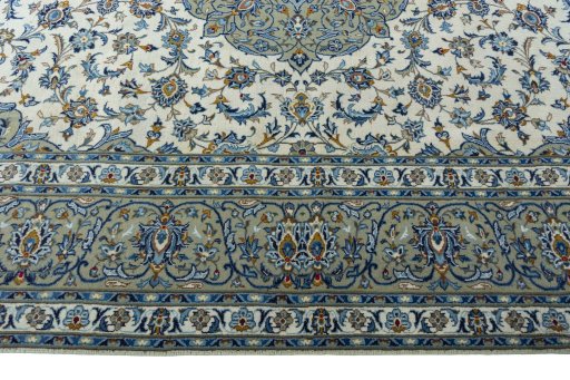 Corner detail of 2000s Kashan rug showing border pattern and Wool pile