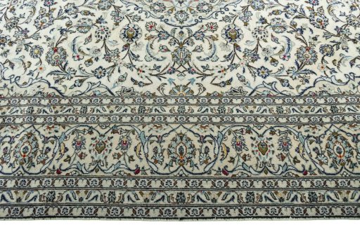 Corner detail of 2000s Kashan rug showing border pattern and Wool pile