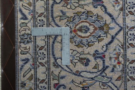 Backside of handmade 2000s Kashan rug showing knot structure and weave density