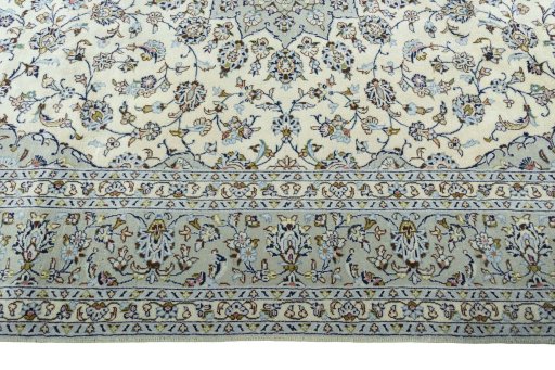 Corner detail of 2000s Kashan rug showing border pattern and Wool pile
