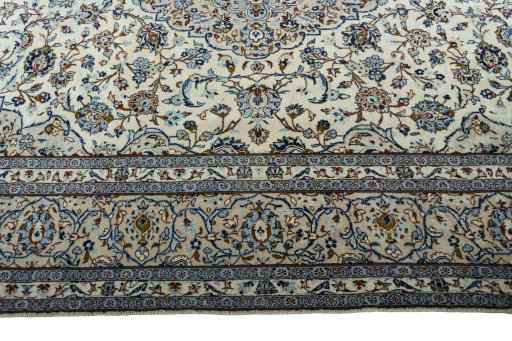 Corner detail of 2000s Kashan rug showing border pattern and Wool pile