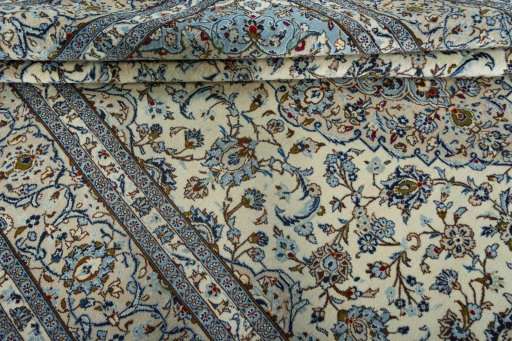 Backside of handmade 2000s Kashan rug showing knot structure and weave density