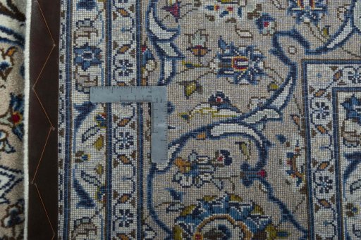 Backside of handmade 2000s Kashan rug showing knot structure and weave density
