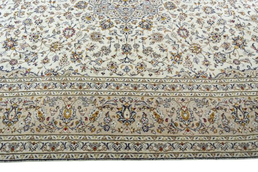 Corner detail of 2000s Kashan rug showing border pattern and Wool pile