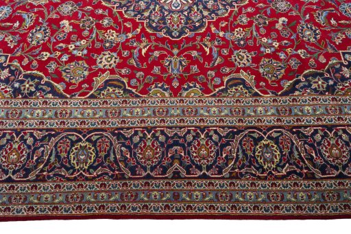Corner detail of 2000s Kashan rug showing border pattern and Wool pile