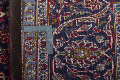 Backside of handmade 2000s Kashan rug showing knot structure and weave density