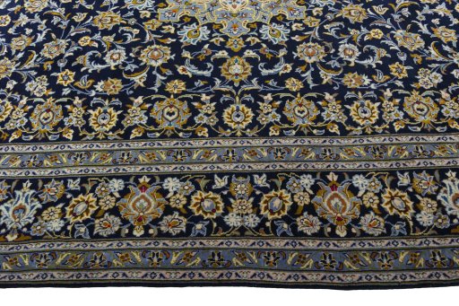 Corner detail of 2000s Kashan rug showing border pattern and Wool pile