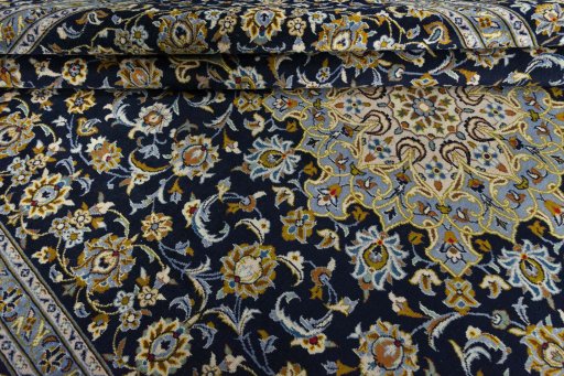 Close-up detail of 2000s Kashan rug from Iran / Persia showing Wool weave