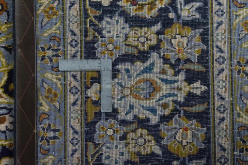 Backside of handmade 2000s Kashan rug showing knot structure and weave density
