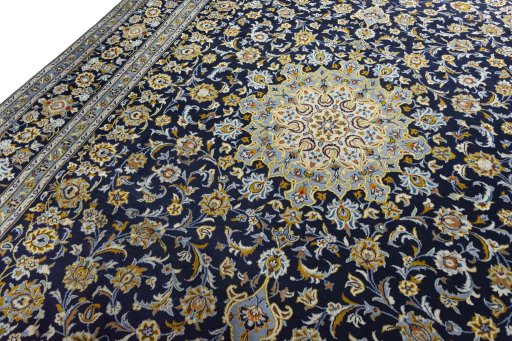 Backside of handmade 2000s Kashan rug showing knot structure and weave density