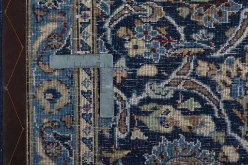 Backside of handmade 2000s Kashan rug showing knot structure and weave density
