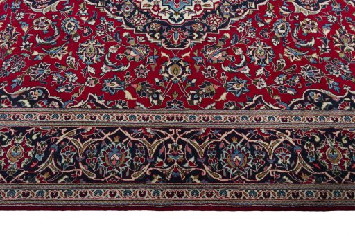 Corner detail of 2000s Kashan rug showing border pattern and Wool pile