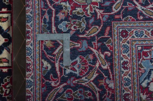 Backside of handmade 2000s Kashan rug showing knot structure and weave density