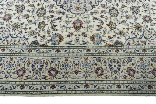 Corner detail of 2000s Kashan rug showing border pattern and Wool pile