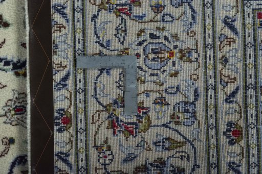 Backside of handmade 2000s Kashan rug showing knot structure and weave density