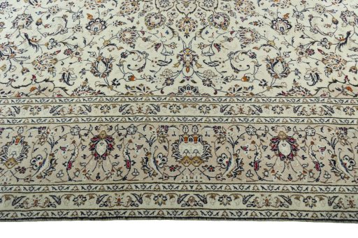 Corner detail of 2000s Kashan rug showing border pattern and Wool pile
