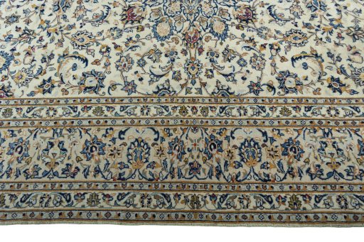 Corner detail of 2000s Kashan rug showing border pattern and Wool pile