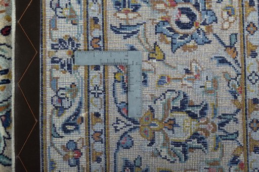 Backside of handmade 2000s Kashan rug showing knot structure and weave density