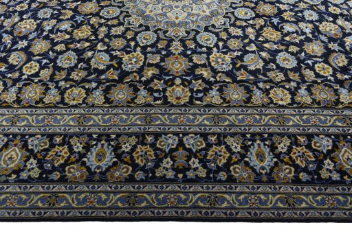 Corner detail of 2000s Kashan rug showing border pattern and Wool pile