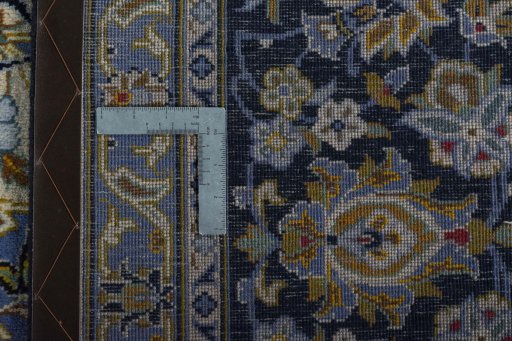 Backside of handmade 2000s Kashan rug showing knot structure and weave density