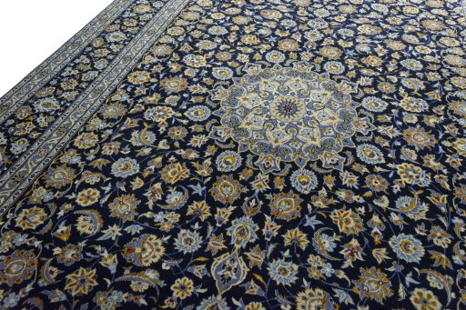 Backside of handmade 2000s Kashan rug showing knot structure and weave density