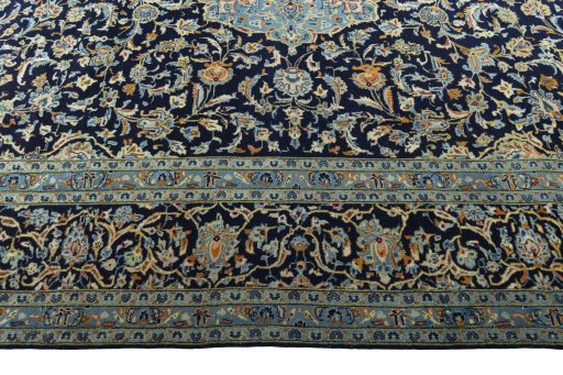 Corner detail of 2000s Kashan rug showing border pattern and Wool pile