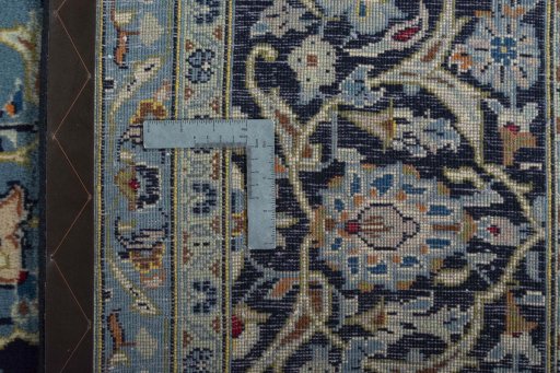 Backside of handmade 2000s Kashan rug showing knot structure and weave density