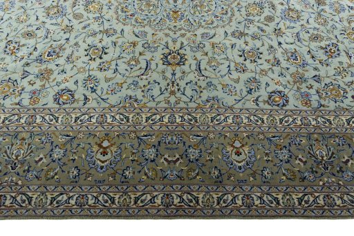 Corner detail of 2000s Kashan rug showing border pattern and Wool pile