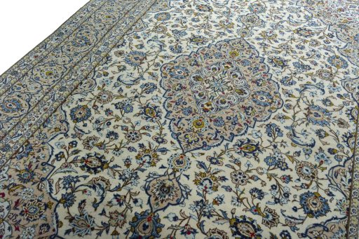 Backside of handmade 2000s Kashan rug showing knot structure and weave density