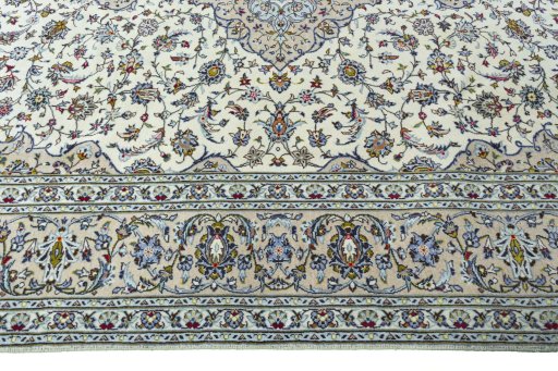 Corner detail of 2000s Kashan rug showing border pattern and Wool pile