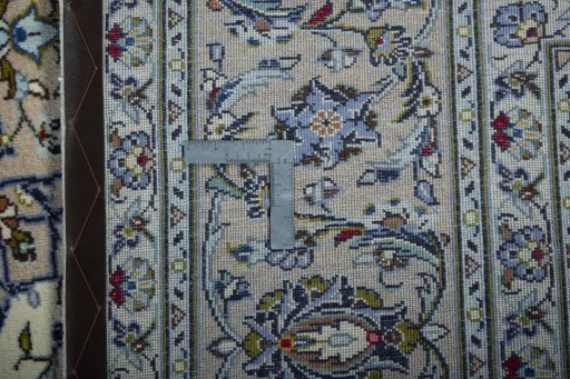Backside of handmade 2000s Kashan rug showing knot structure and weave density