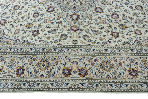 Corner detail of 2000s Kashan rug showing border pattern and Wool pile