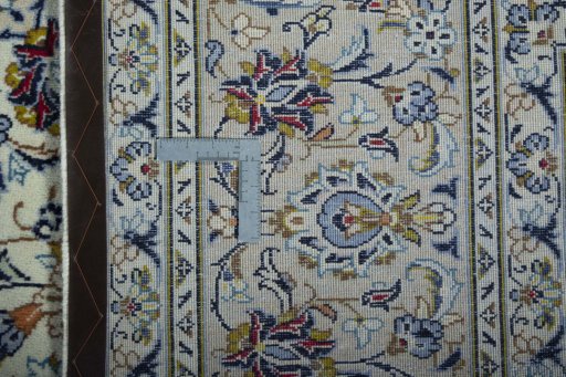 Backside of handmade 2000s Kashan rug showing knot structure and weave density