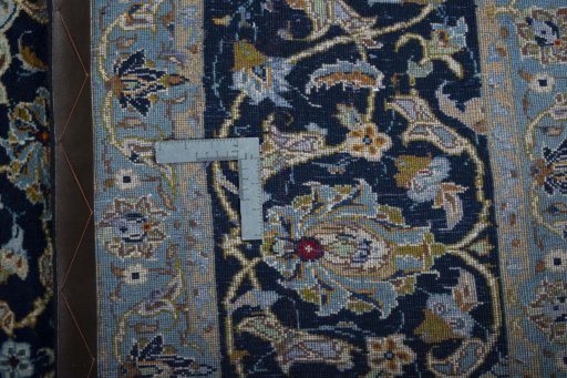 Backside of handmade 2000s Kashan rug showing knot structure and weave density