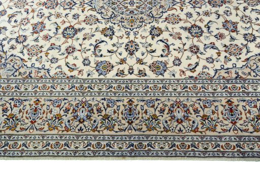 Corner detail of 2000s Kashan rug showing border pattern and Cork pile