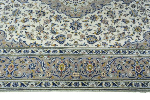 Corner detail of 2000s Kashan rug showing border pattern and Wool pile