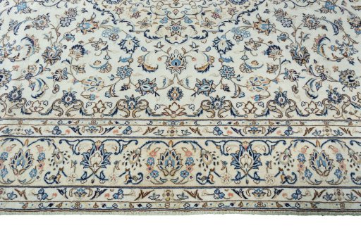 Corner detail of 2000s Kashan rug showing border pattern and Wool pile