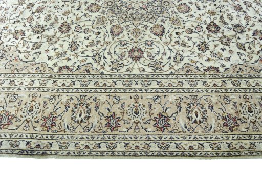 Corner detail of 2000s Kashan rug showing border pattern and Wool pile