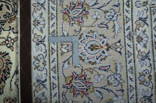 Backside of handmade 2000s Kashan rug showing knot structure and weave density