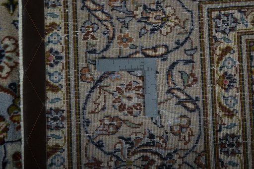 Backside of handmade 2000s Kashan rug showing knot structure and weave density