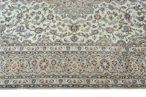 Corner detail of 2000s Kashan rug showing border pattern and Wool pile