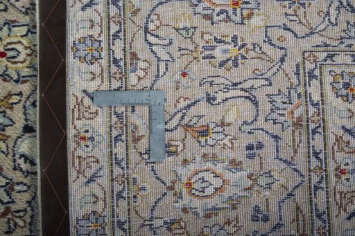Backside of handmade 2000s Kashan rug showing knot structure and weave density