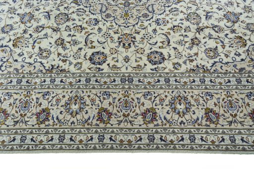 Corner detail of 2000s Kashan rug showing border pattern and Wool pile