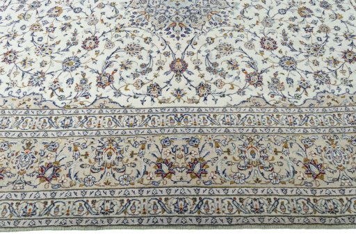 Corner detail of 2000s Kashan rug showing border pattern and Wool pile