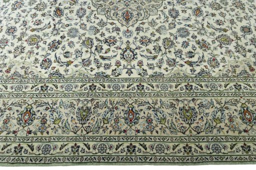 Corner detail of 2000s Kashan rug showing border pattern and Wool pile